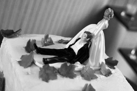 a model bride drags her groom  across the cake